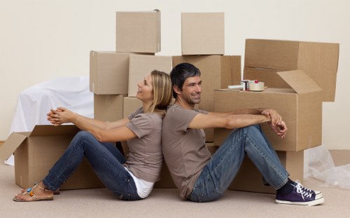House movers carrying furniture through a Bromley property entrance